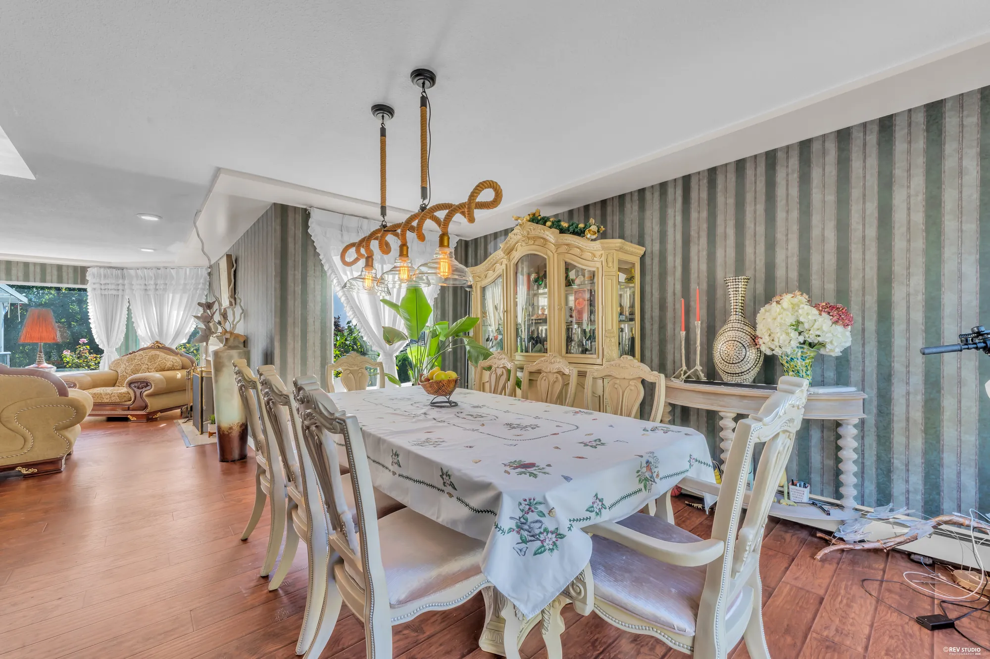 The dining room toward the living room, the table and the china cabinet