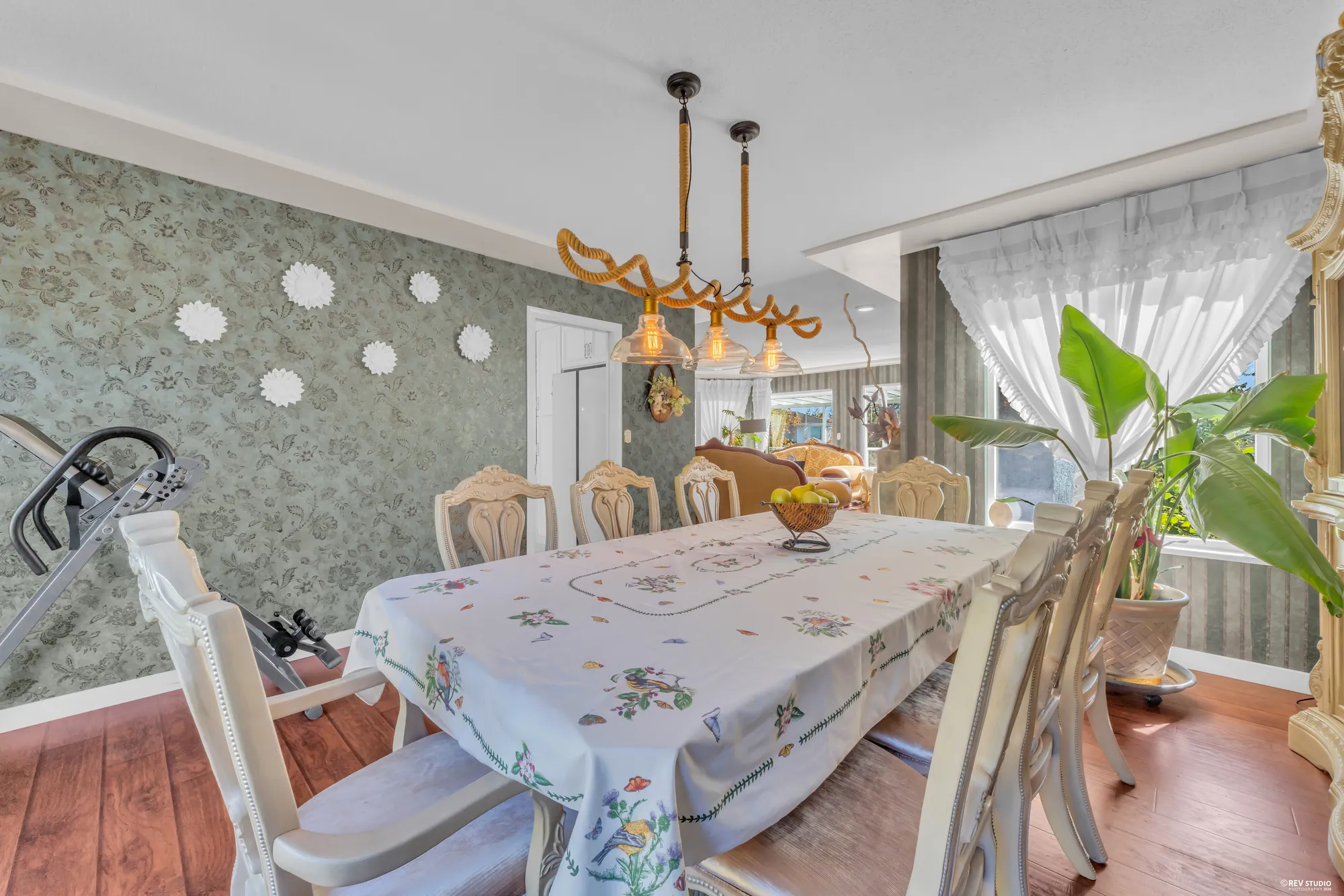 The dining room from the kitchen side, the pendants over the table, the windows
