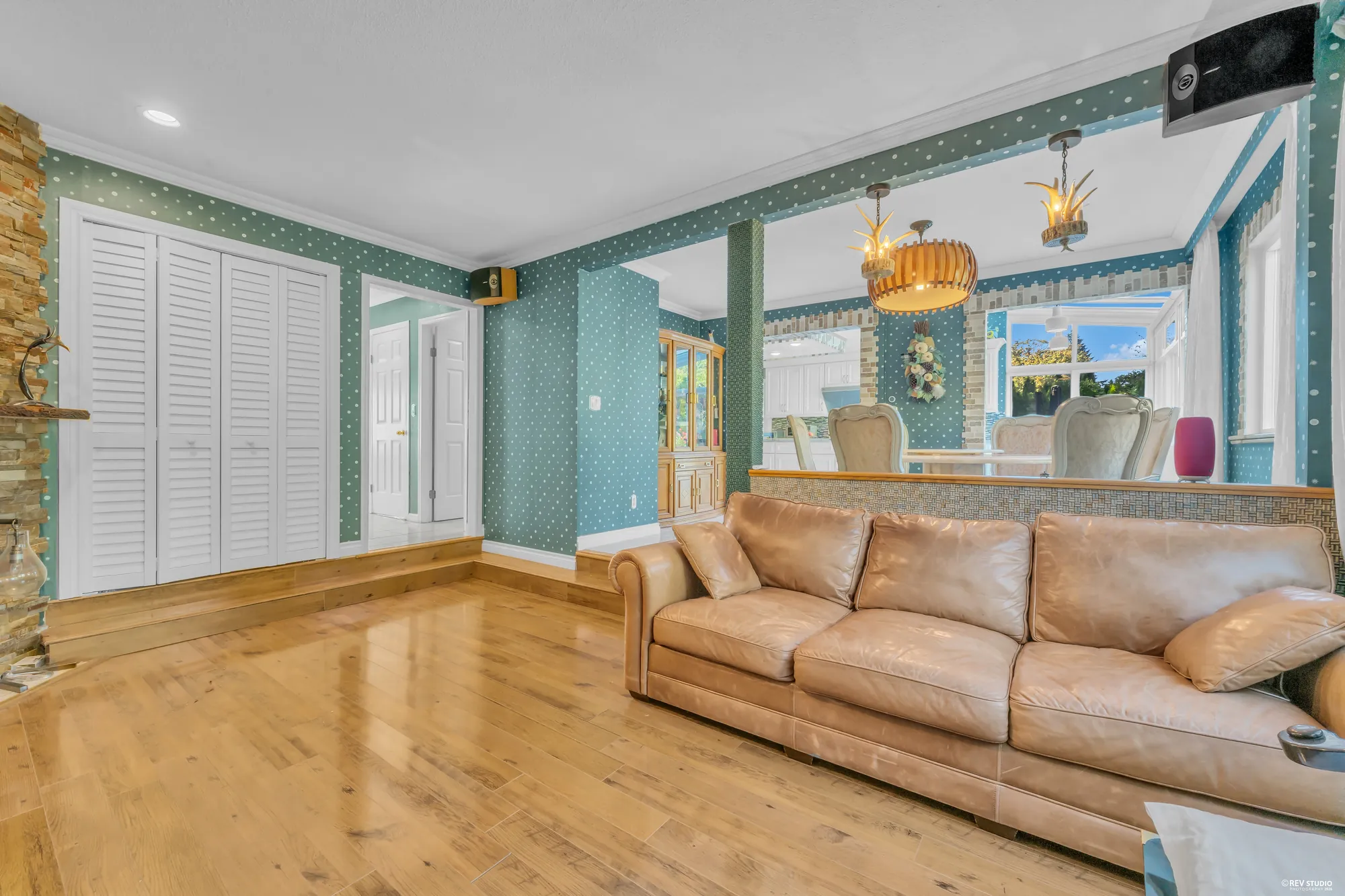 The family room toward the hall and its closets, the sofa in the corner