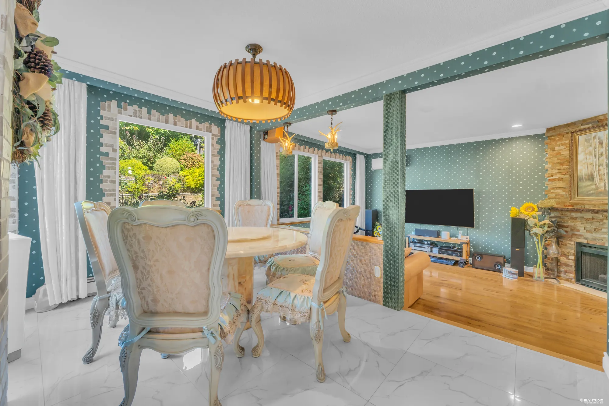 The nook from the family room, the table under its pendant, the kitchen on the left